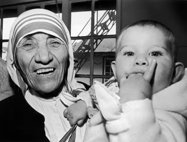 Mother Teresa holds nine-month-old Christina Ott from Switzerland.