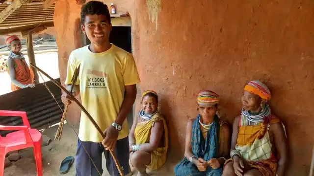 Arjun Kirsangi shows his indigenously made bow and arrow, as his aunts look over. He belongs to the Upper Bonda tribe of Malkangiri, and is the first person from his village to give his matriculation exams. (Photo: Ankush Vengurlekar)