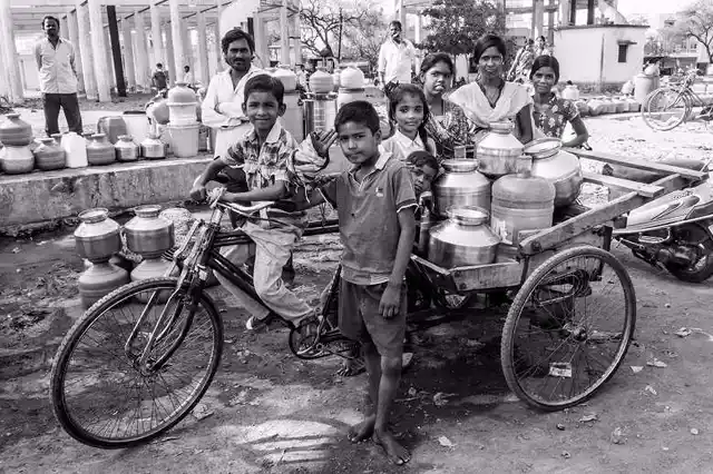 Lugging water filled jars back home has become a daily chore. This family has hired a tricycle for the day. Schools in the region have closed early owing to the water crisis and children say they were having great fun playing ‘water porters’ during their vacation. (Photo: Ameya Marathe, curated by Nikhil Inamdar)