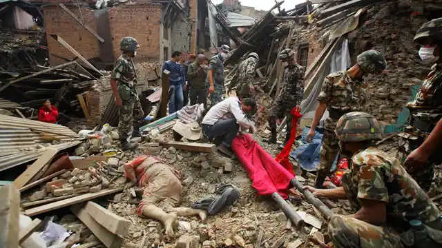 In this 26 April 2015 file photo, the dead body of a woman is seen after rescue workers recovered it from debris following earthquake in Bhaktapur near Kathmandu, Nepal. 