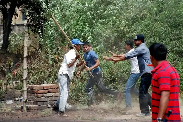 Two groups clash outside a polling booth during State Assembly polls in Jamuria, West Bengal. (Photo: PTI)