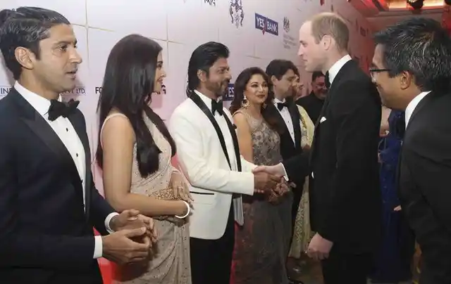 Prince William shakes hands with Shah Rukh Khan as Farhan Akhtar patiently waits for his royal moment of glory. (Photo: Reuters)