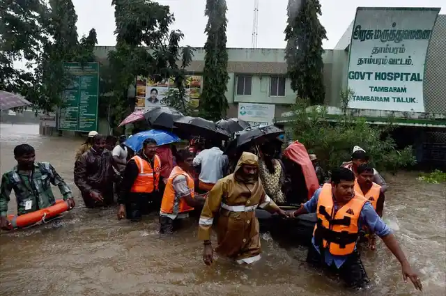 Rescuers shifting patients from a flooded hospital after heavy rains in Chennai on Tuesday. (Photo: PTI)