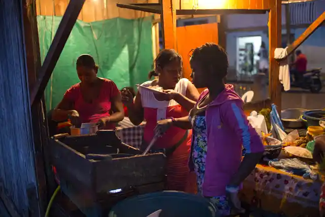 In the southwestern Colombian port city of Tumaco, women run a street-side restaurant specialising in fried fish. Women continue to earn less, have fewer assets, and are largely concentrated in vulnerable and low-paying activities. Seventy-five percent of women’s employment in developing regions is informal and unprotected. (Photo Courtesy: UN Women/Ryan Brown)