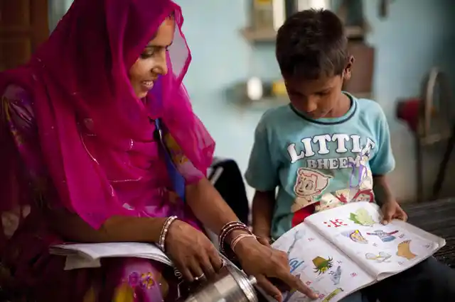 In the northern Indian state of Rajasthan, a mother shares the joy of learning as she helps her son with his homework. A child born to a mother who can read is 50 percent more likely to survive. Every year of education beyond grade four that a woman receives, reduces risks of her child dying by 10 percent. (Photo Courtesy: UN Women/Shaista Chishty)