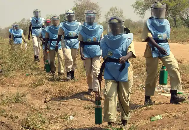 An all-female de-mining team in action in South Sudan deals with the legacy of landmines from Sudan’s civil war. Women de-miners are not uncommon and have worked on the numerous minefield from Bosnia to Iraq, Sri Lanka, Tajikistan and other countries. The job involves strapping on 25 kilos of equipment and searching for deadly explosives. (Photo Courtesy: UNMAS/Elena Rice)