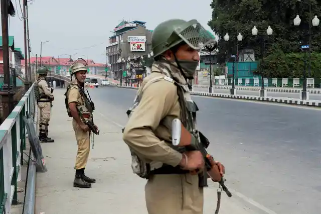 CRPF jawans stands guard on third consecutive day in Srinagar on Monday, 11 July 2016. (Photo: PTI)