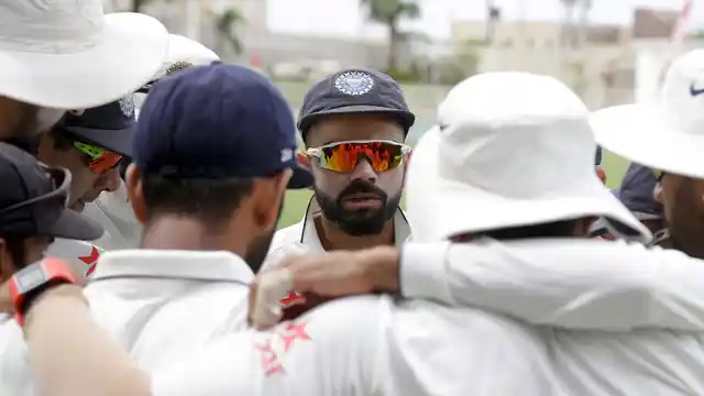 India’s captain Virat Kohli talks to teammates prior to the start of day one of their second Test match against West Indies at the Sabina Park. 