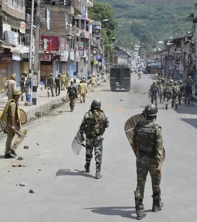 Security forces clash with locals at Baramulla town as a complete shutdown is being observed across Kashmir Valley. (Photo: IANS)