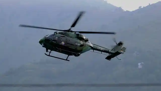An Indian army helicopter flies above the army base that was attacked in the town of Uri, west of Srinagar. (Photo: AP)