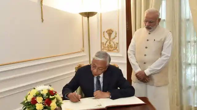 Prime Minister Narendra Modi looks on as President of Myanmar, Htin Kyaw signs the visitors book, at Hyderabad House, in New Delhi on 29 August 2016. (Photo: IANS/PIB)