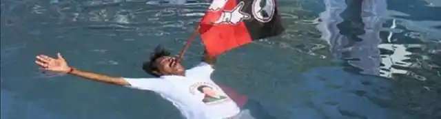 An MLA from AIADMK held a party flag and floated for Amma’s long life. (Photo Courtesy: <i>The News Minute</i>)