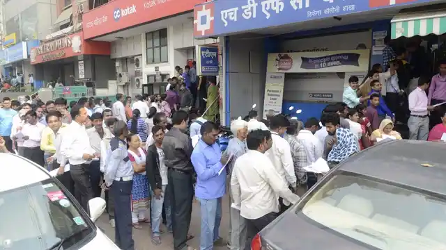 People wait outside banks to exchange currency notes in New Delhi on 11 November 2016. (Photo: IANS)
