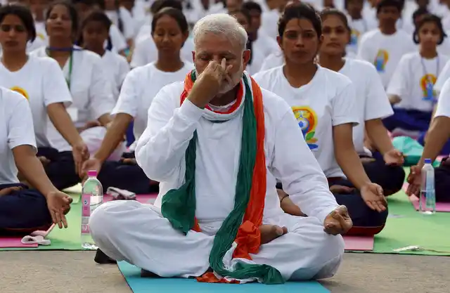 Prime Minister Narendra Modi performs yoga with
others during a yoga camp to mark the International Day of Yoga, in New Delhi,
India on June 21, 2015. (Picture: Reuters)