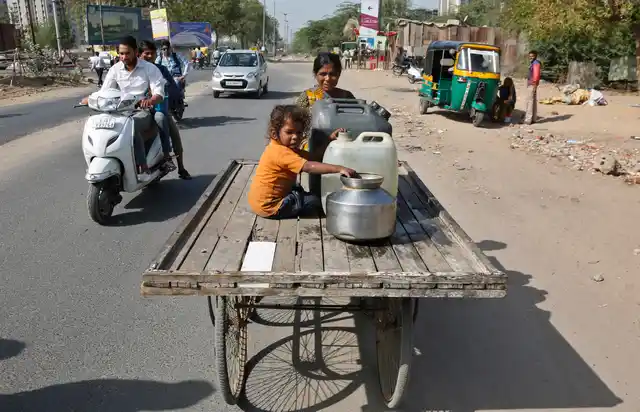 A woman transports drinking water on a handcart on the eve of World Water Day in Ahmedabad. (Photo: AP)