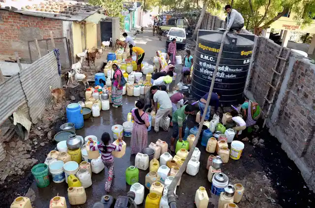 People fetching water from a tank on the eve of World Water Day in Bhopal. (Photo: PTI)