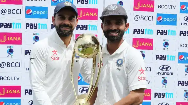 Virat Kohli (L) and Ajinkya Rahane (R) pose with the Border-Gavaskar Trophy that India won after beating Australia in the home Test series in 2017.