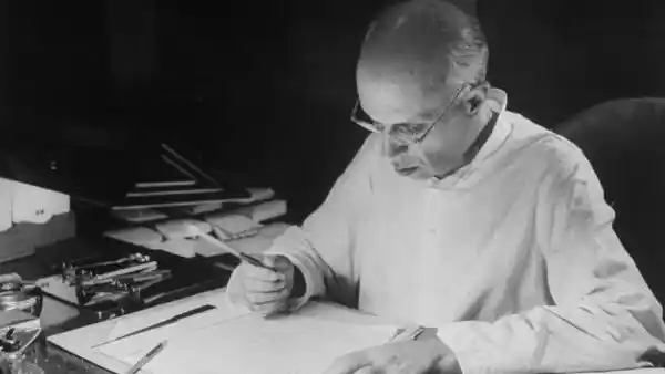 A rare photo of Nehru writing at his desk at Anand Bhawan.