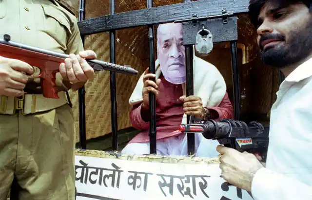 A demonstrator posing as former Indian prime minister and Congress Party leader PV Narasimha Rao sits inside a fake jail cell during a demonstration organised by dissident congress workers in New Delhi August 2. The dissidents were demanding Rao quit as Party leader because of his alleged involvement in a notorious cheating case. (Photo: Reuters)