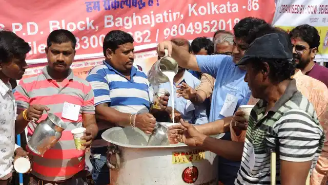 People participate in a “cow milk party” organised by BJP in Kolkata on 10 June 2017. (Photo: IANS)