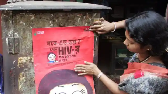 An activist puts up a poster during an AIDS awareness drive in Sonagachi, Kolkata’s red light district. Image used for representation.