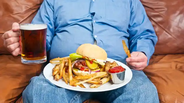 Put that fry down! Binge-eating junk and being a couch potato will do no good to your skin.