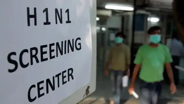 People wearing surgical masks walk out of an H1N1 flu screening centre. Image used for representational purpose.
