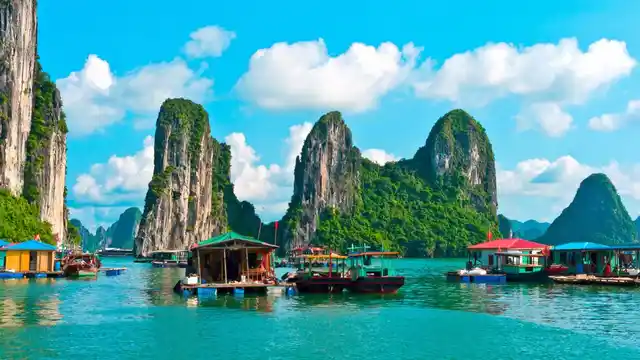 Floating village near rock islands in Halong Bay. 