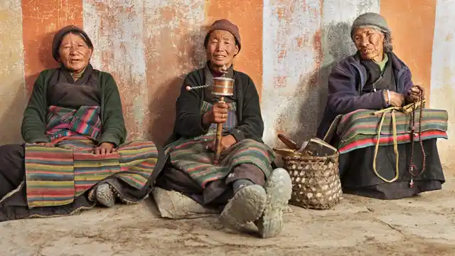 Three Tibetan women praying in Lo Manthang, Nepal. 