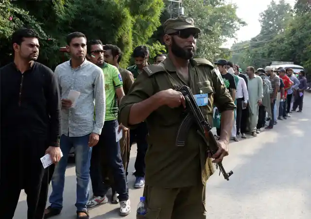 A Pakistani security personnel stands alert outside Gaddafi Stadium to ensure security ahead of the start of first Twenty20 cricket match between the World XI team and Pakistan, in Lahore.