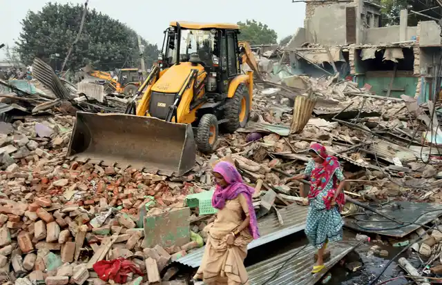 Delhi Development Authority bulldozers carry out demolition work at Kathputli Colony.