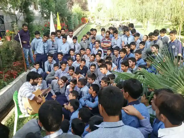 Musician Ovais Ahmad performs at Scholars Boarding School, Harwan, on the International Day of Peace.