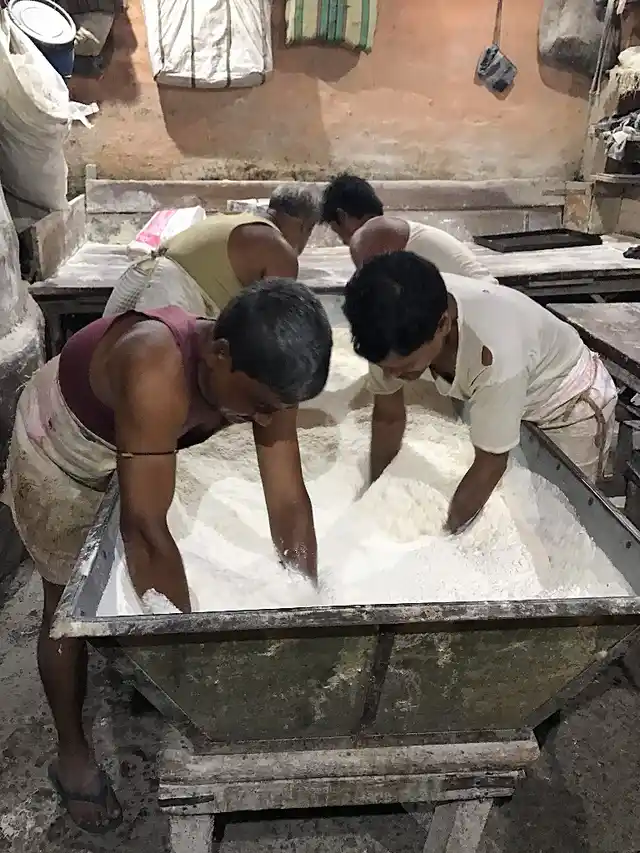 Workers mix a combination of flour, salt, water, yeast, sugar and oil in this tub.