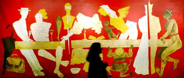 A visitor looks at a painting by MF Husain during an exhibition in Mumbai.