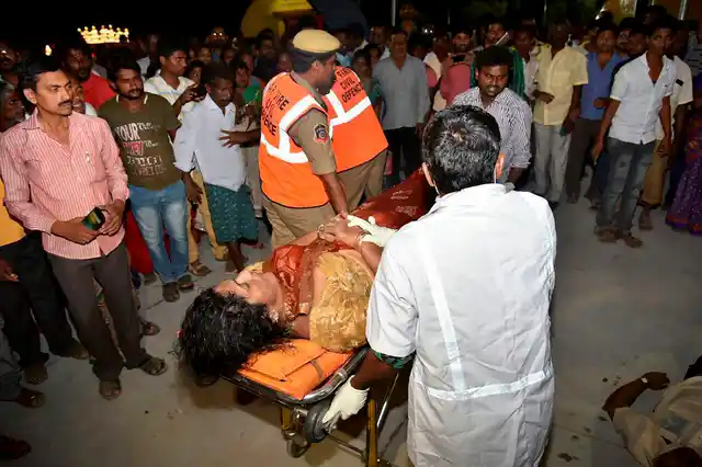 An injured being taken to hospital after an overloaded boat carrying 38 people capsized in the Krishna river near Vijayawada on Sunday evening.