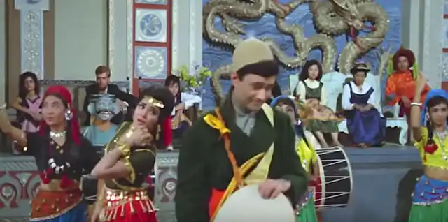 Vyjayanthimala burning up the dance floor as Dev Anand looks on in <i>Jewel Thief.</i>