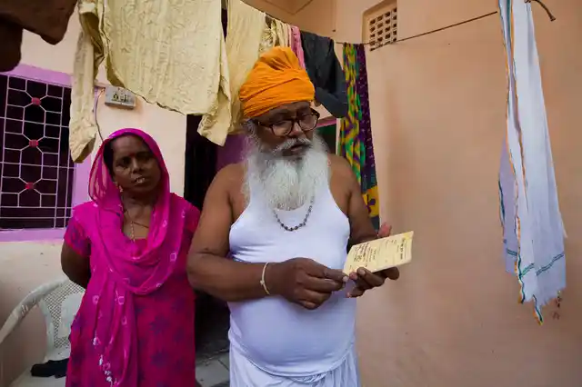 Roshan Lal and Pushpa, his wife, with their yellow card. 