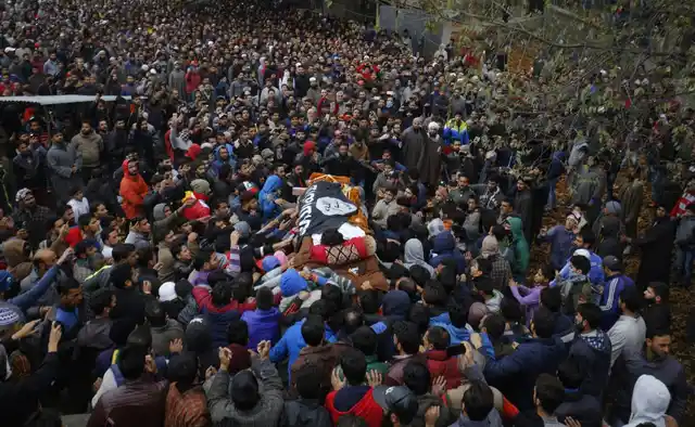 Funeral procession of the militant Mugees Ahmad Mir whose coffin was draped in ISIS flag and carried through Srinagar for burial on Sunday.