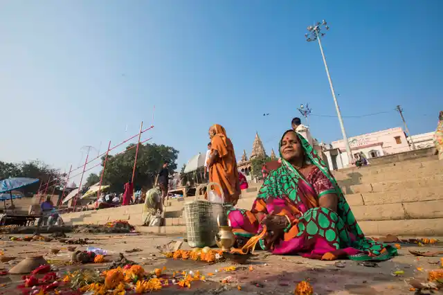 A woman awaits as her family takes the holy dip in Varanasi’s ghats.