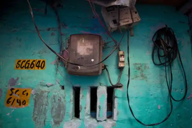 A metre seen in Sanjay Basti, North Delhi. Tata Power-DDL, that provides electricity in the area, have a yellow plate marking as none of the houses in the basti have house numbers.