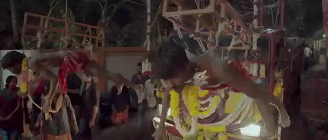 The narrative is interspersed with footage of an actual <i>Garudan Thookkam</i> ceremony in honour of the goddess Kali, in which men endure excruciating rituals.