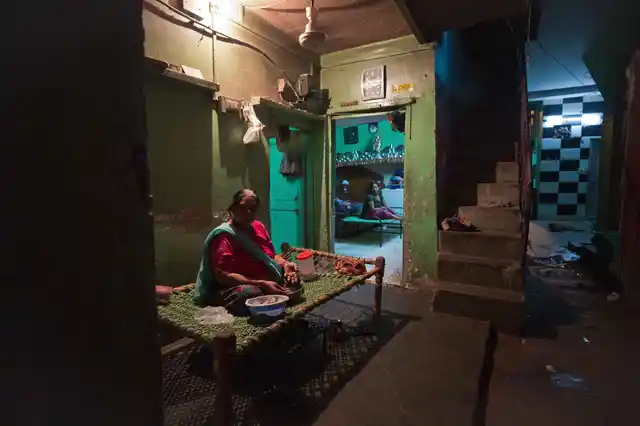 Sharda, who has been a resident of Majnu ka Tila for over three decades, sits in the courtyard of her house. She feels safe after electricity metres have been installed, and can comfortably be seen out till late at night, north Delhi. 