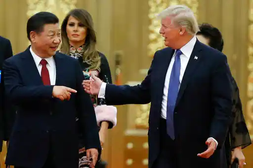 US President Donald Trump and China’s President Xi Jinping arrive for the state dinner with the first ladies at the Great Hall of the People in Beijing on 9 November 2017.