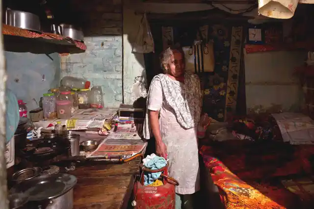 Veena Batra in her one-room house at Majnu ka Tila. Currently, Veena doesn’t have a metre, but has sublet a connection from her son; her own metre was removed due to non-payment of dues. 