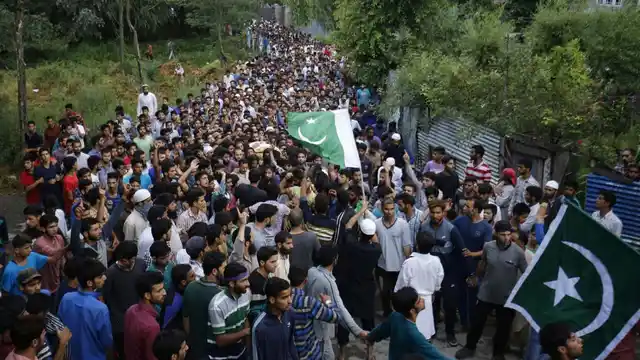 People attend funeral procession of militant Burhan Wani at his village in Tral of Jammu and Kashmir’s Pulwama district on 9 July 2016.