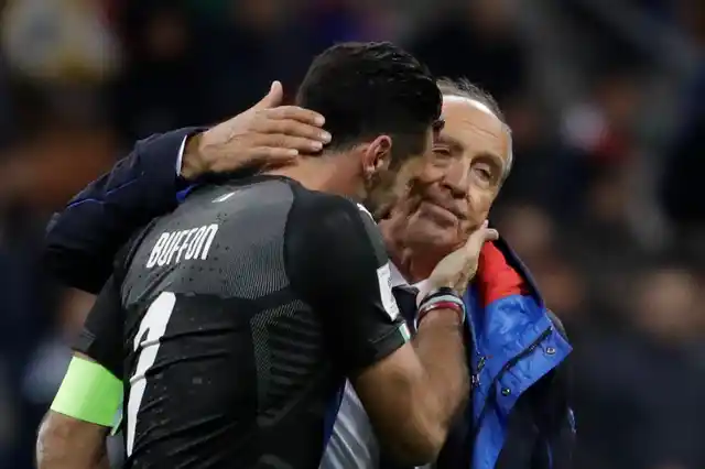 Italy goalkeeper Gianluigi Buffon is comforted by Italy coach Gian Piero Ventura.
