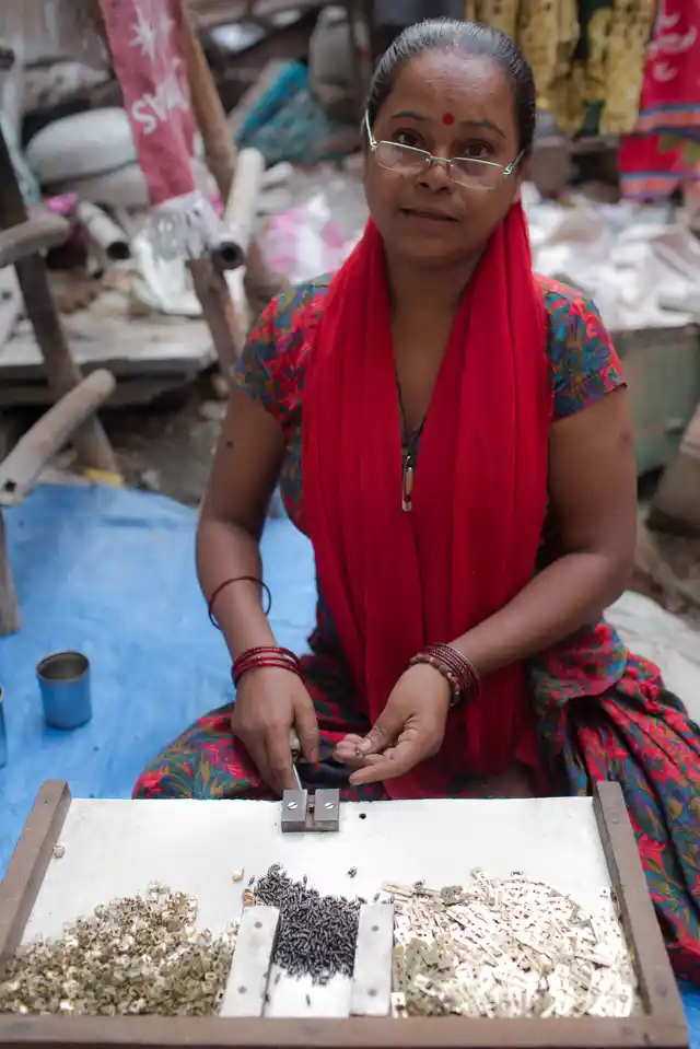 Shristi works from her home to place springs into switches. For every 144 springs fitted into the switches, she earns Rs 3. On an average, she earns about Rs 50 per day. 