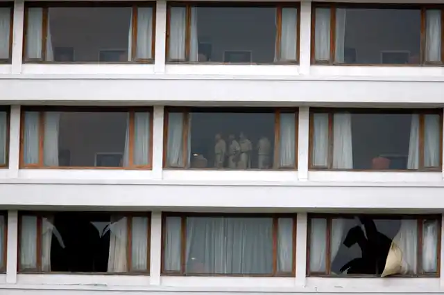 Policemen survey the hotel rooms post the horrific attack