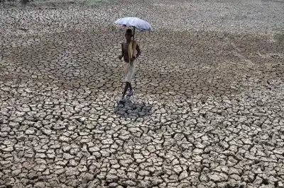 Bhubaneswar: A man walks through a dried pond on the outskirt of Bhubaneswar. The capital city of Odisha recorded 45 Degree Celsius. (Photo: IANS)