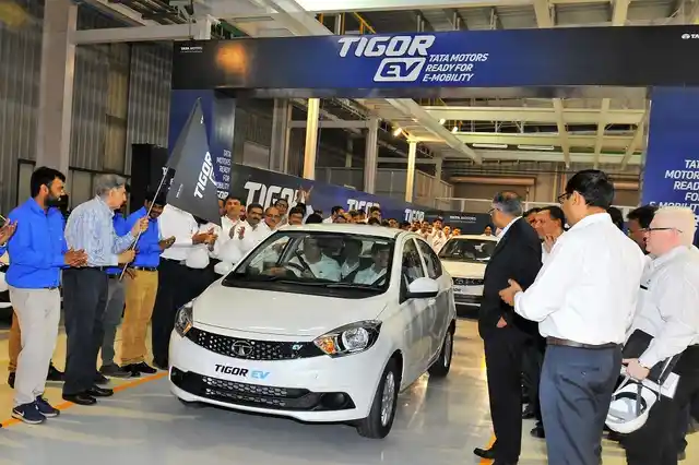 Guenter Butschek, CEO & MD, Tata Motors, drives off the first Tigor EV sedan post the ceremonial flag off at the Sanand plant. 